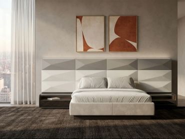 Modern bedroom with abstract art and geometric headboard.