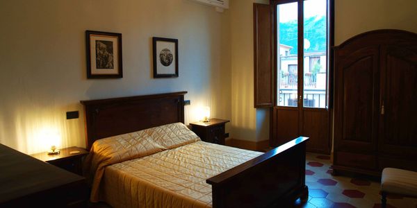 Elegantly furnished with antiques; one of the three bedrooms in a vacation apartment, Sulmona, Italy