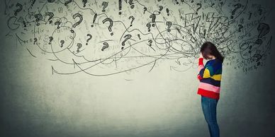 A person overwhelmed by chaotic thoughts and questions.