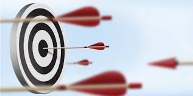 Darts flying towards a bullseye on a target board.