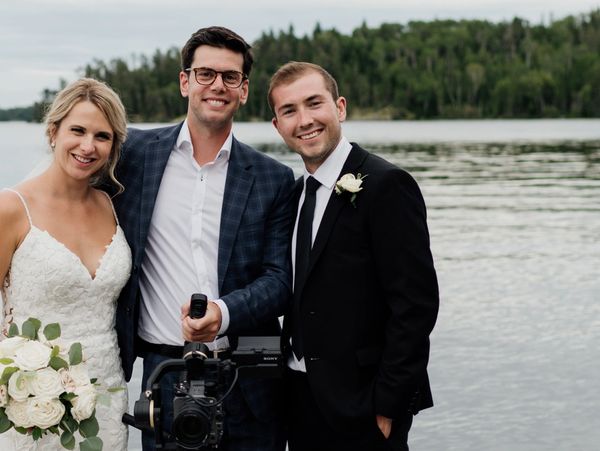 Wedding Videographer with bride and groom at their wedding at the lake