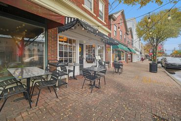 Empty outdoor seating at a breakfast café on a quiet autumn day.