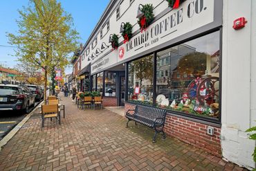 Chatham Sandwich Shop and T.M. Ward Coffee Co. decorated for the holidays with outdoor seating.