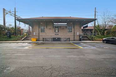 Chatham Station building with parking in front, clear sky.