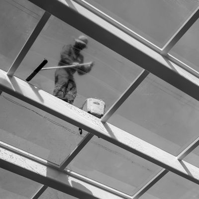 Man washing a glass ceiling.