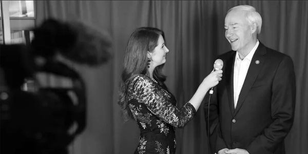 Asa Hutchison being interviewed at an event.