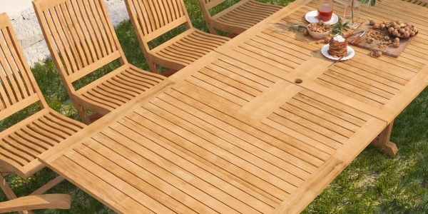 Outdoor wooden dining table set with snacks and drinks on the table.