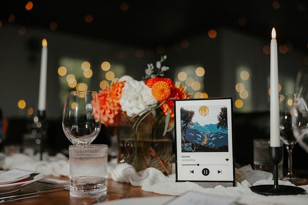 Elegant table setting with flowers, candles, and a music-themed centerpiece.