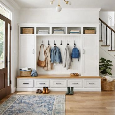 Organized mudroom with hooks, storage cabinets, and wooden bench seating.