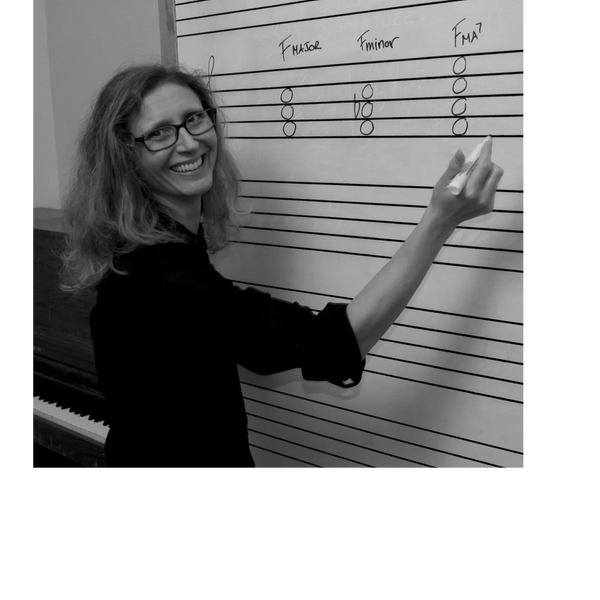 Tamara Hey has written out the chords F major, F minor, and F major 7  on a whiteboard.
