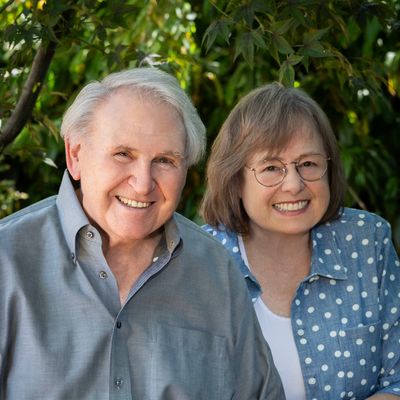 Smiling elderly couple enjoying a sunny day outdoors.