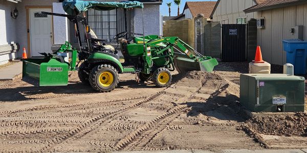 Clearing a yard , grading then spreading rock