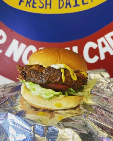 Fried sandwich in front of sign