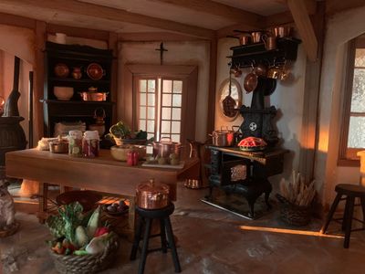 Cozy rustic kitchen with copper pots and vegetables.