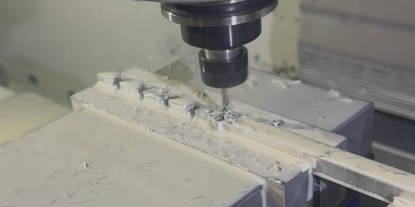 CNC milling machine machining metal part.
