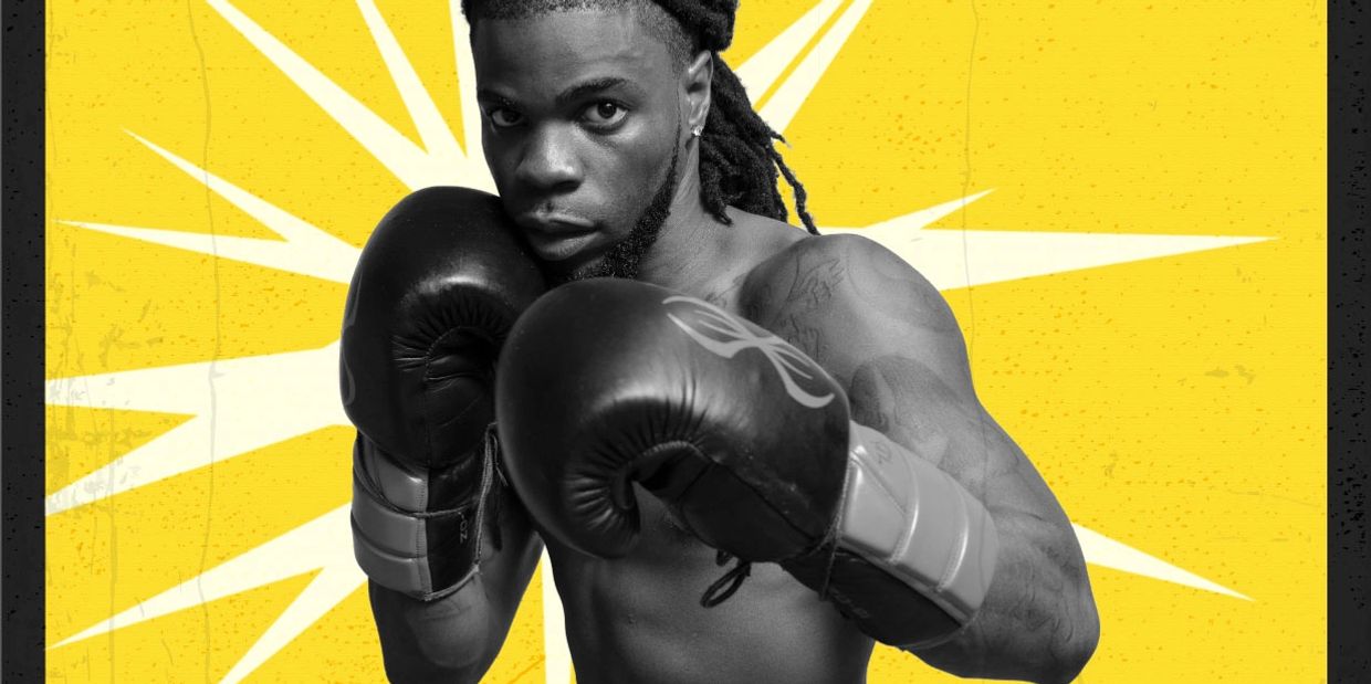 Boxer in black gloves poses fiercely against a yellow starburst background.