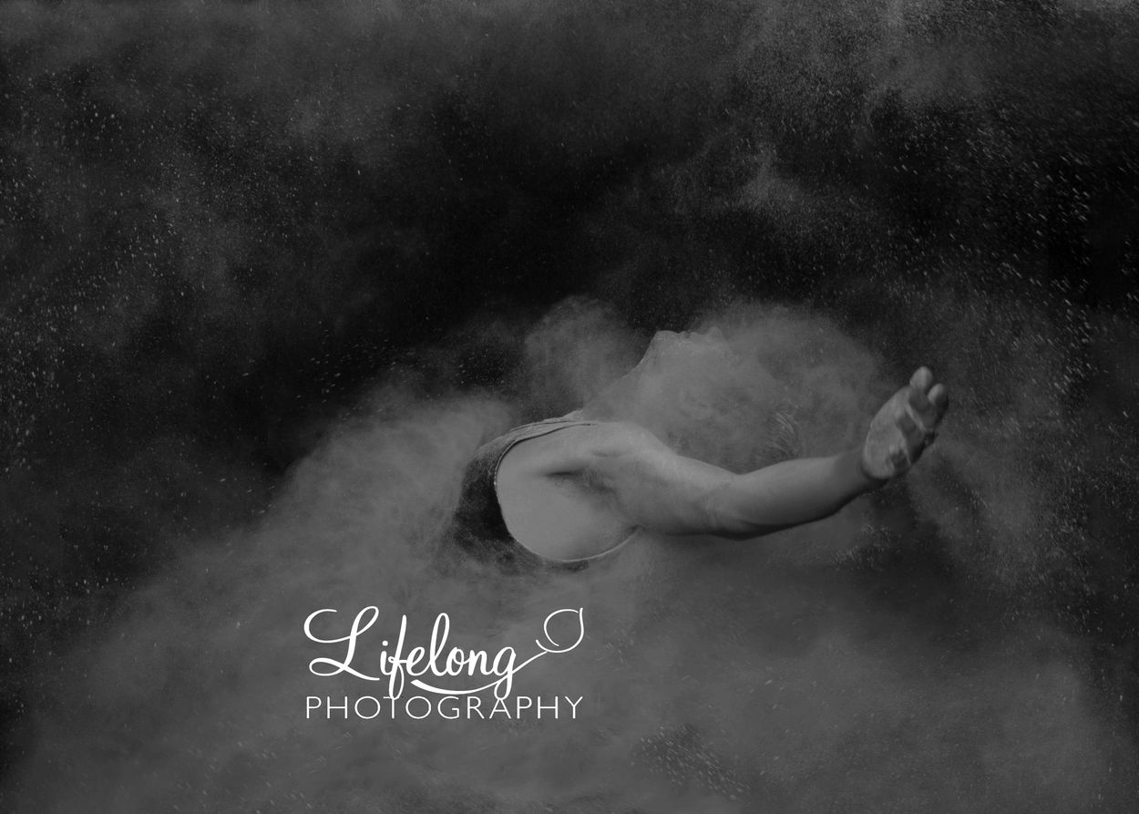 Lifelong Photography. Portrait of male ballet dancer in studio, using powder for dramatic effect.