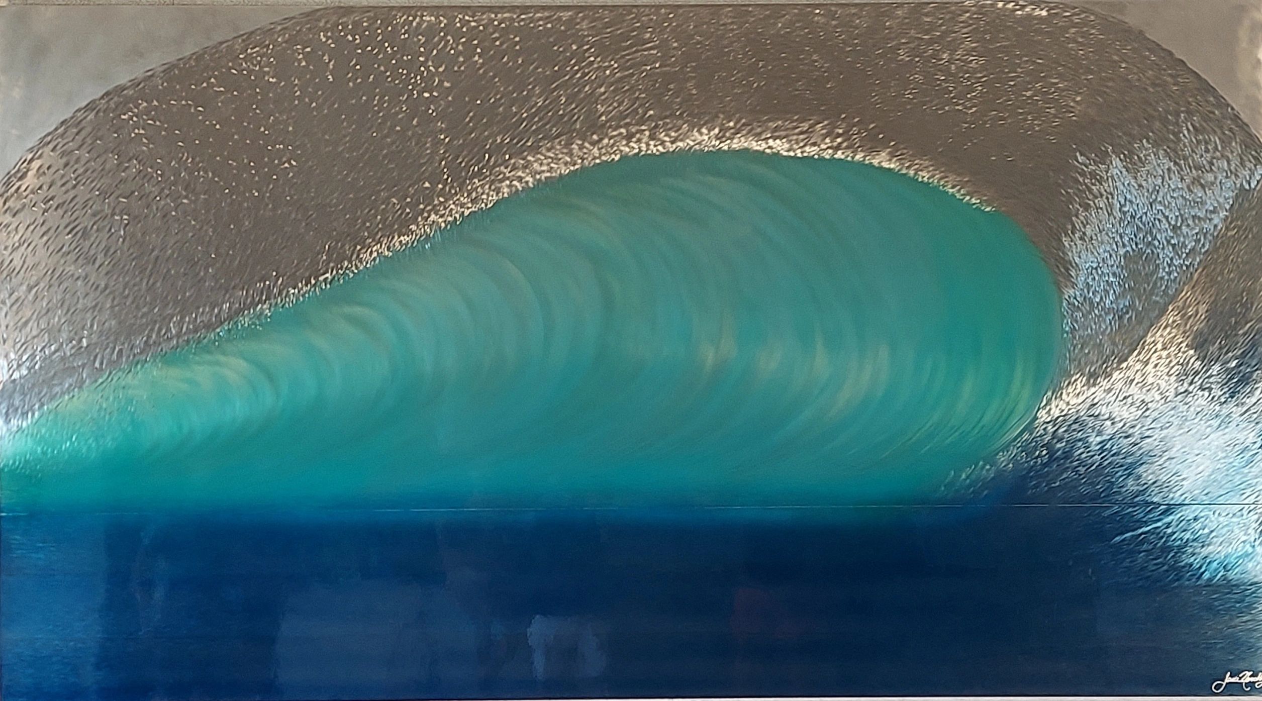 This piece is called "Ohana Nalu". This could very well be the largest metal wave in the world.
