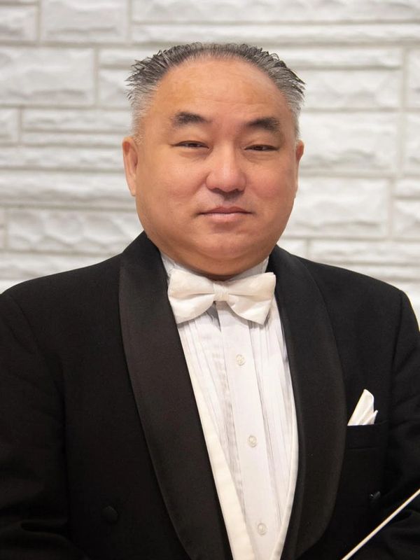 Man in tuxedo with white bow tie.