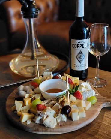 Our Russian hookah offering with a wine bottle and cheese charcuterie board in Orlando, FL