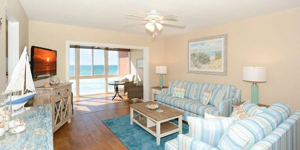 Coastal living room with ocean view and nautical decor.