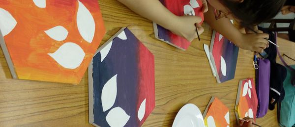 Children painting a canvas in a kid's art class in Edinburgh