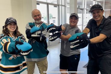 4 people posing for a photo Wearing sharks Gloves