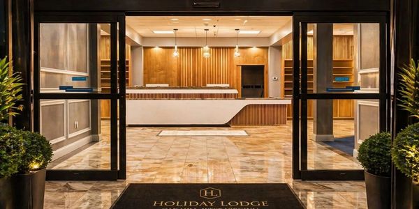 Modern hotel lobby with wooden reception desk.