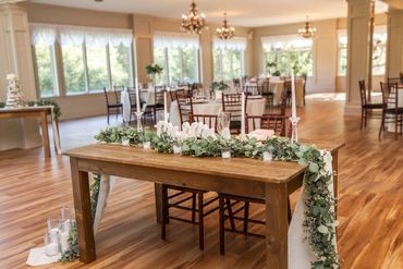 a view of the floral decorations on the barn sweetheart table in the ballroom 