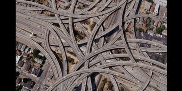Complex aerial view of a multi-level highway interchange.