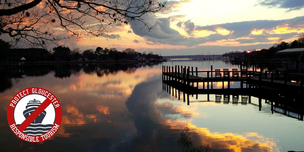 Sunset over a calm river with a dock and a responsible tourism logo.