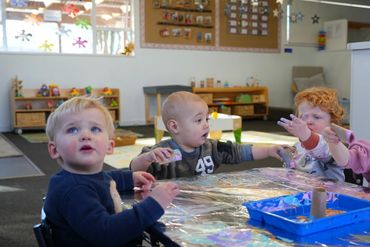 Kiwi Kids Nursery children painting together