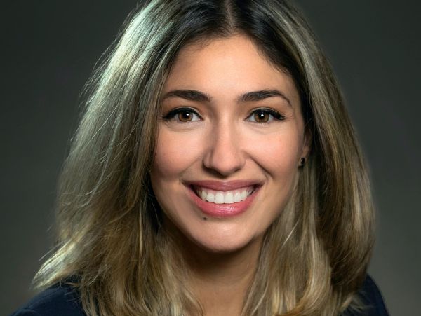 Smiling young woman with blonde hair.