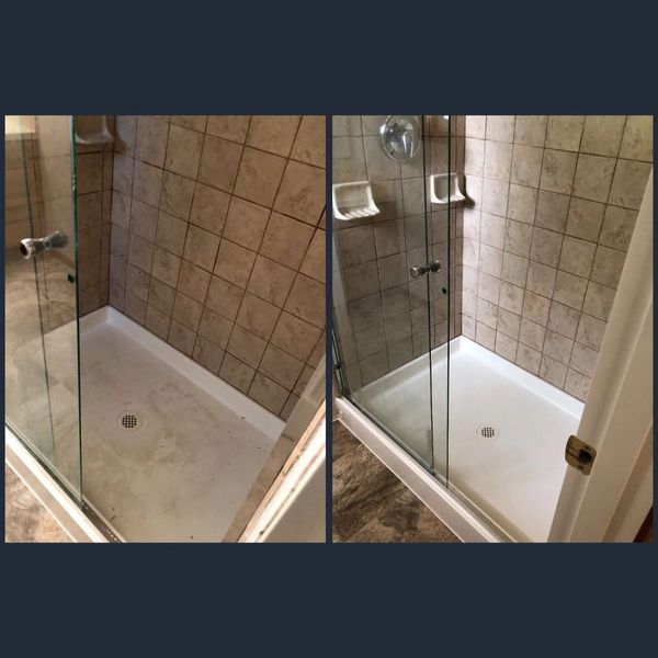 A dirty stand in shower that has been cleaned.