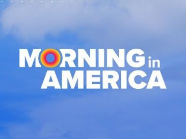 Morning in America text with a colorful sunrise design on a blue sky background.