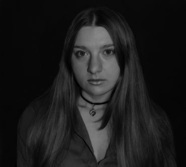 Black and white portrait of a woman with long hair.