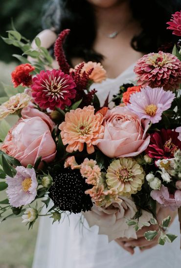 Colorful summer bouquet with peach, berry and burgundy flowers