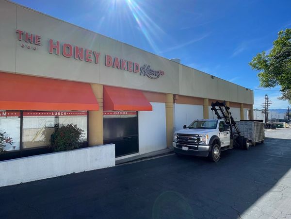 Dumpster rental container filled with commercial construction waste in Los Angeles