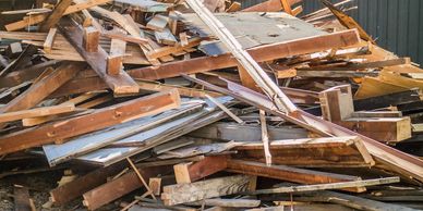 Image of construction debris near dumpster — indicates construction debris removal