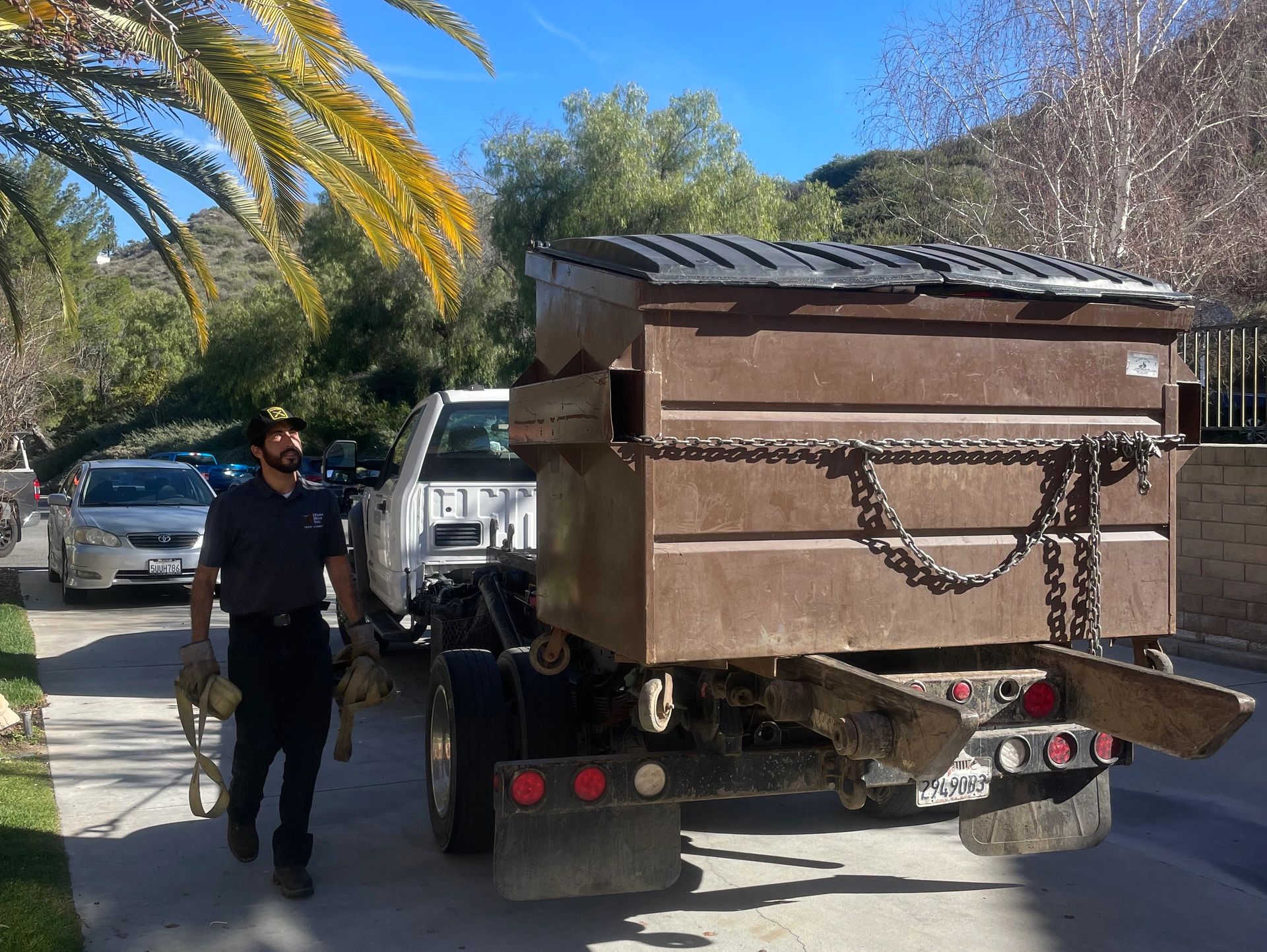 Zoom Bins truck delivering a dumpster in a Los Angeles neighborhood — fast and reliable disposal sol