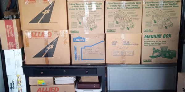 Stacked moving boxes on furniture.