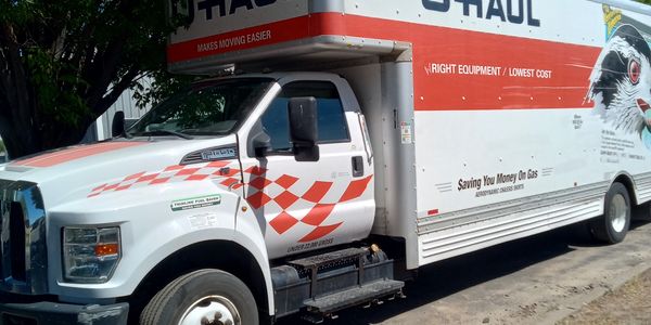 U-Haul moving truck parked on the side of the road.