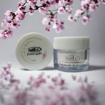Premium acrylic nail product with delicate pink blossoms around it.