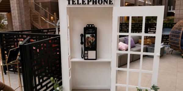Vintage phone booth with a couple's photo inside.