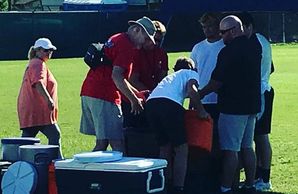 Cooling zone with tent, cold tub and coolers filled with ice. Six people assisting with CWI