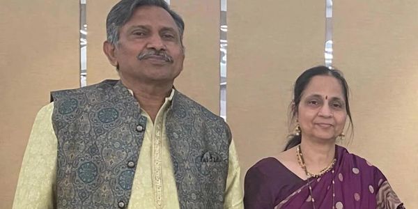 A man and woman in traditional Indian attire posing together.