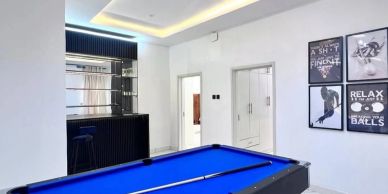 Modern room with blue pool table and wall art.