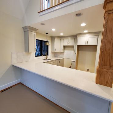 Quartz counter top with Arrow tile backsplash
