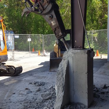 Using heavy equipment for the concrete wall and pier demolition