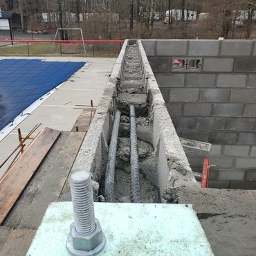 Block bond beam with rebar reinforcement at sill height